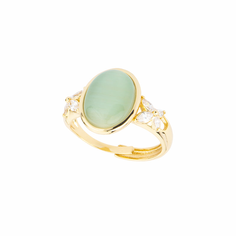 Anello gambo in brass dorato con top in cat eye ovale verde mela e fiori di zirconi navette clear