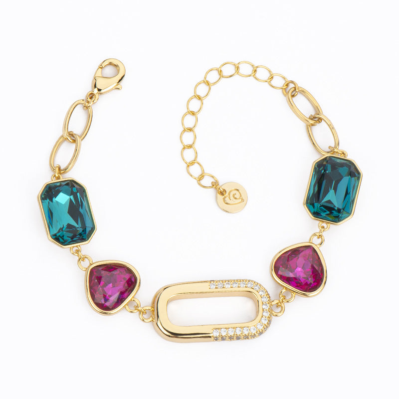 Bracciale con centrale ovale in brass dorato con pavè di zirconi e cristalli trilliant fucsia e ottagonali blu di londra - misura regolabile