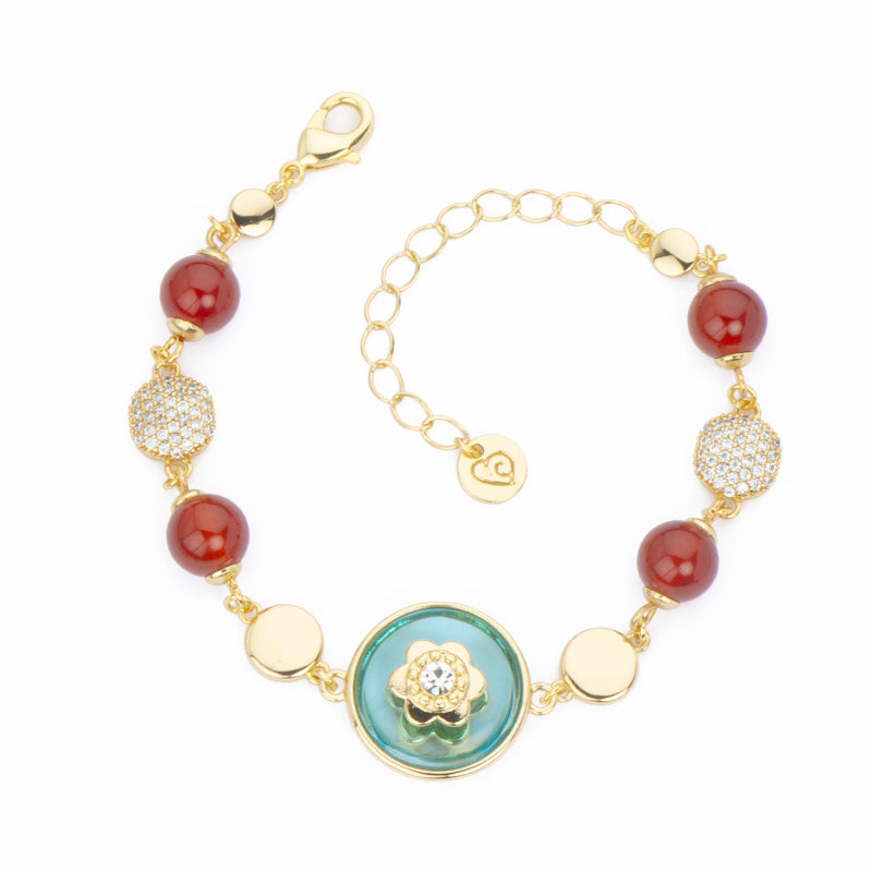 Bracciale elementi in brass dorato lisci e in pavè di zirconi con pietre red agata e centrale a bottone in cristallo azzurro - Misura Regolabile